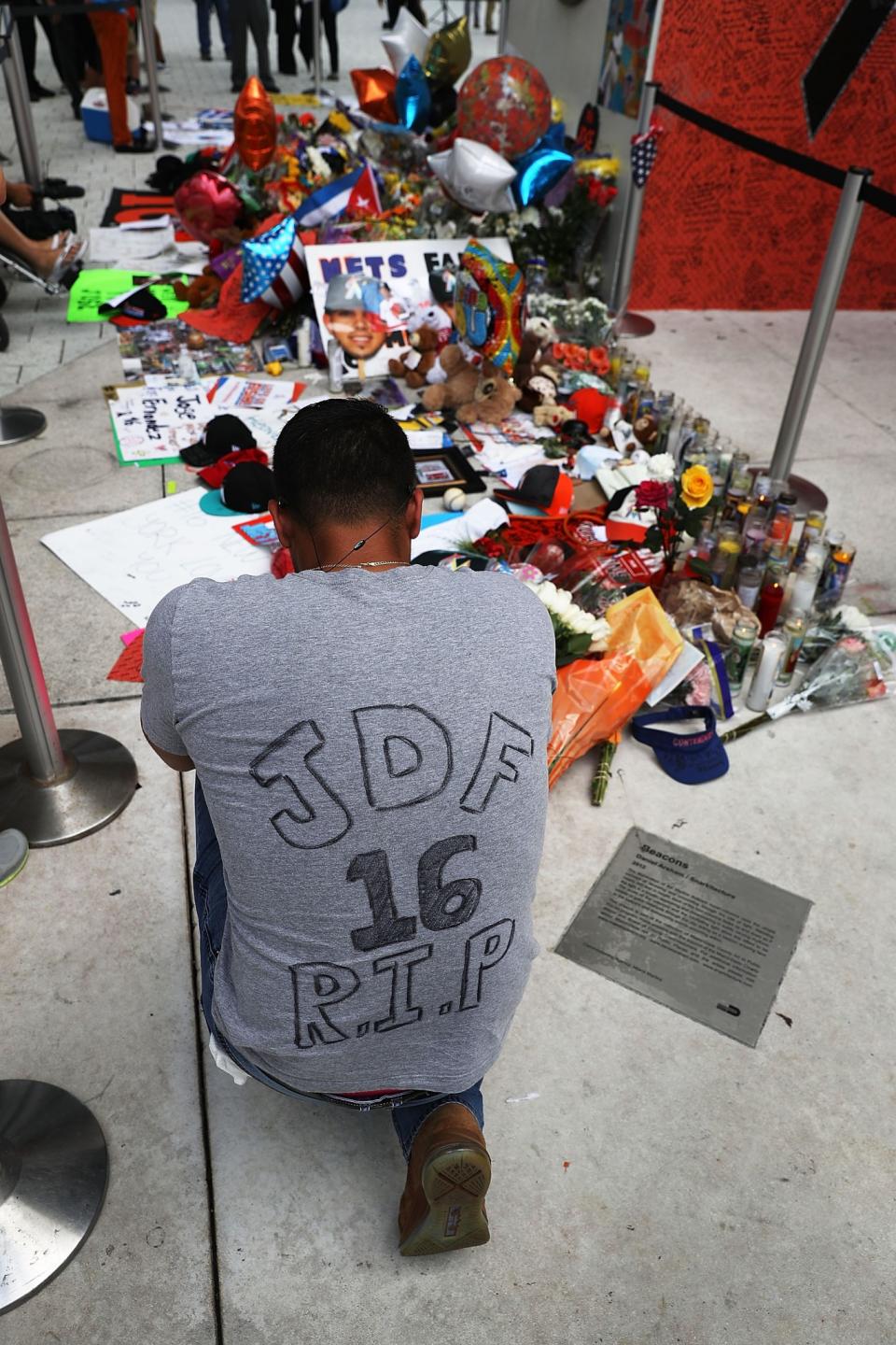 <p>Elian Gonzalez pays his respects at a memorial before the hearse carrying Miami Marlins pitcher Jose Fernandez passes in front of the Marlins baseball stadium on September 28, 2016 in Miami, Florida. Mr. Fernandez was killed in a weekend boat crash in Miami Beach along with two friends. (Photo by Joe Raedle/Getty Images) </p>