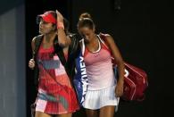 Serbia's Ana Ivanovic (L) and Madison Keys of the U.S. walk back on court after play in their third round match is resumed, at the Australian Open tennis tournament at Melbourne Park, Australia, January 23, 2016. REUTERS/Issei Kato