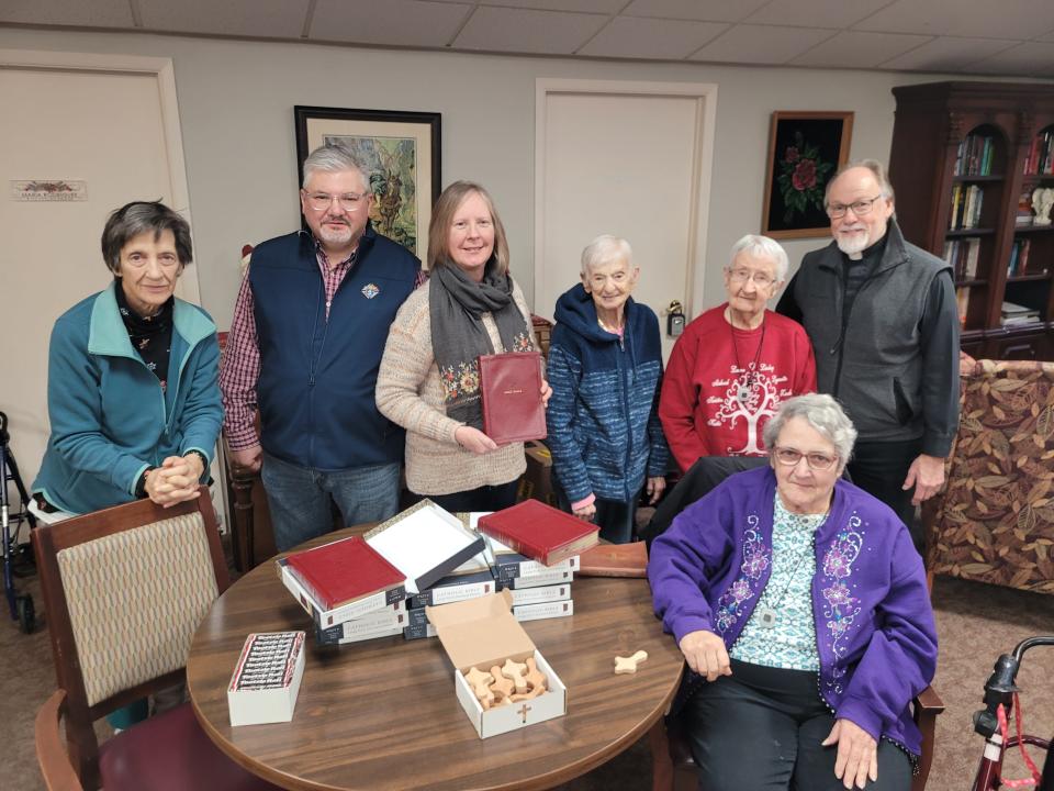 Marion Place residents recently received large print Bibles donated by the Monroe Council #1266 Knights of Columbus. Pictured are Linda Williams, left, Grand Knight Julian Rios, Sharon Venier, Theresa Celso, Stella Battistone, Judy Powers and Deacon Mike Stewart.