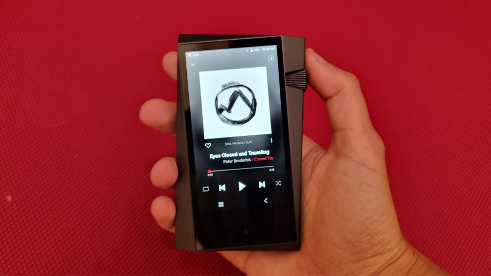 Astell & Kern A&norma SR35 in hand on a red background