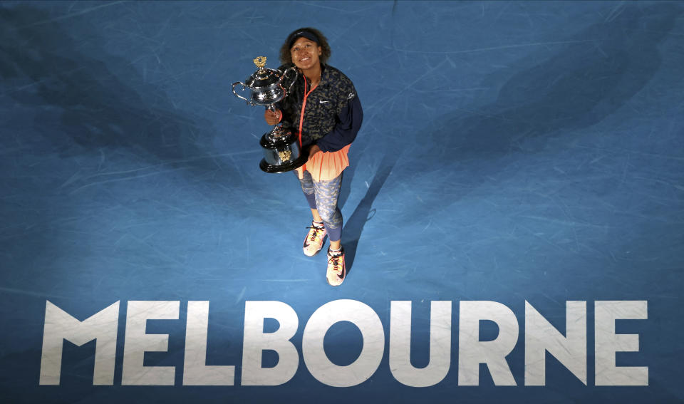 Japan's Naomi Osaka holds the Daphne Akhurst Memorial Cup defeating United States Jennifer Brady in the women's singles final at the Australian Open tennis championship in Melbourne, Australia, Saturday, Feb. 20, 2021.(AP Photo/Hamish Blair)
