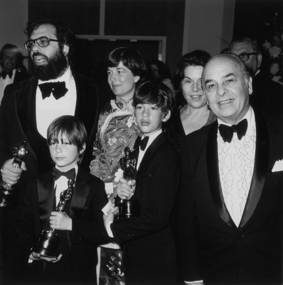 8th April 1975:  American film director Francis Ford Coppola stands with his family, holding three Oscars for his film, 'The Godfather, Part II,' during the 47th Annual Academy Awards at the Dorothy Chandler Pavilion of the Los Angeles Music Center, Los Angeles, California. Clockwise, from left, his wife, Eleanor, his parents, Pennito and Carmine, and sons, Roman and Gian Carlo.  (Photo by Frank Edwards/Fotos International/Getty Images)