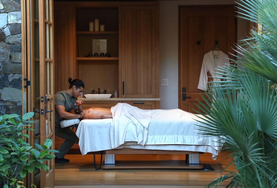 Kaleo Gonzalez gives a massage to Michelle Ostermyer at the very private and exclusive Sensei Porcupine Creek in Rancho Mirage, Calif., Nov. 29, 2022. “What people want from the Coachella Valley is rest and relief, but that rest and relief is not afforded to the people who drive the economy,” said Lift to Rise Founder and CEO Heather Vaikona.