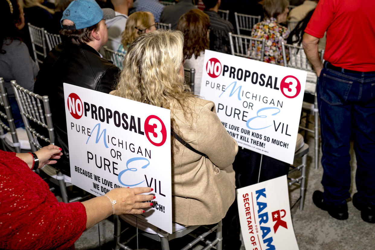 Signs in opposition of Proposal 3 are pictured during the Unite America rally at Fairlane Banquet Center in Dearborn, Mich., on Oct. 30. 