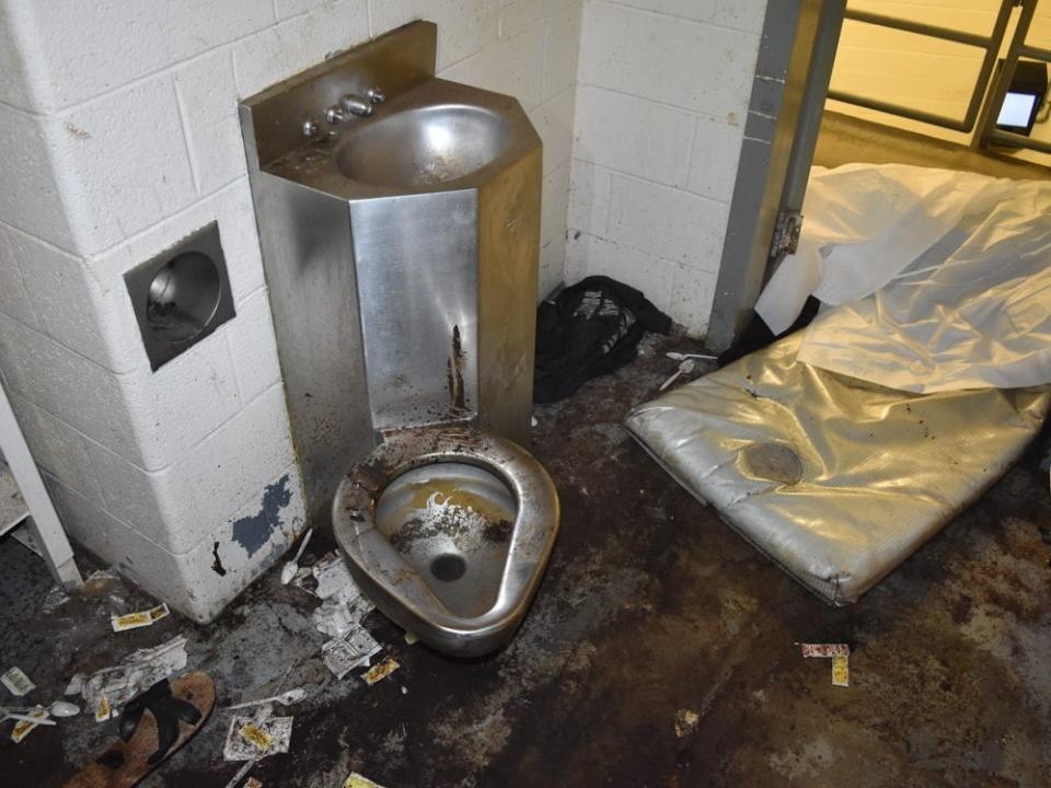 Photos of the jail cell where Lashawn Thompson was held show squalid conditions.