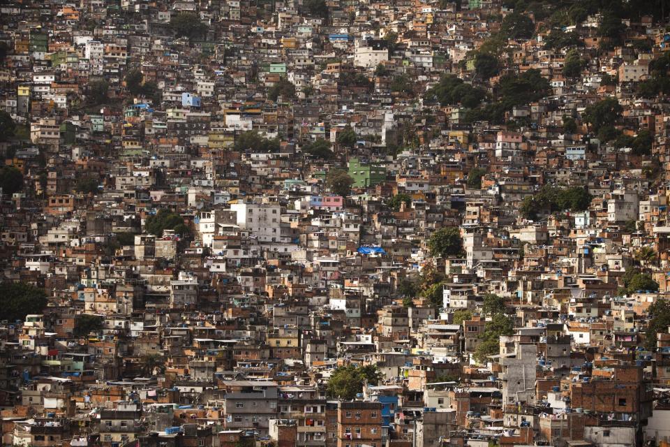 Homes crowd the Rocinha shantytown in Rio de Janeiro, Brazil, Tuesday, May 22, 2012. Local officials and human rights groups are working to give legal title to tens of thousands of residents of shantytowns like Rocinha, a process that increases their wealth and gives them greater access to credit, as well as peace of mind. The programs so far are just a start at tackling a widespread problem: A third of the people in Rio state, nearly 5 million people, don't have title to their homes, an uncertainty shared by most of the approximately 1 billion people who living in slums globally. (AP Photo/Felipe Dana)