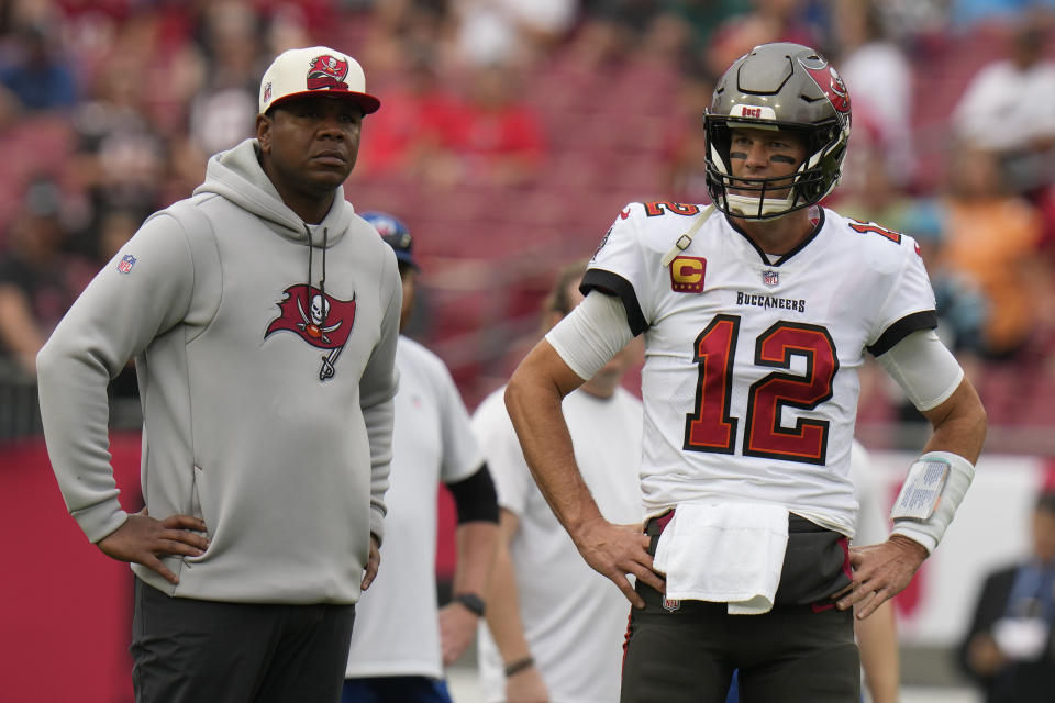 FILE - Tampa Bay Buccaneers quarterback Tom Brady and offensive coordinator Byron Leftwich watch before an NFL football game between the Carolina Panthers and the Tampa Bay Buccaneers on Sunday, Jan. 1, 2023, in Tampa, Fla. Byron Leftwich has been fired as offensive coordinator of the Tampa Bay Buccaneers, a person with knowledge of the dismissal told the Associated Press on Thursday, Jan. 19, 2023.(AP Photo/Chris O'Meara, File)