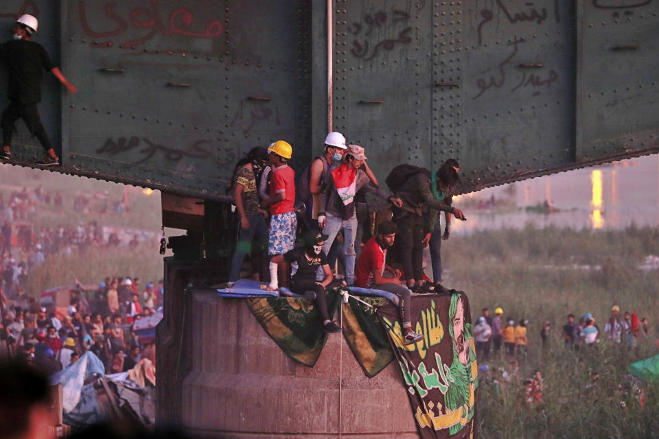 Protesters stage a sit-in under a bridge that leads to the Green Zone where many government offices and embassies are located, during ongoing anti-government protests in Baghdad, Iraq, Tuesday, Nov. 5, 2019. (AP Photo/Hadi Mizban)