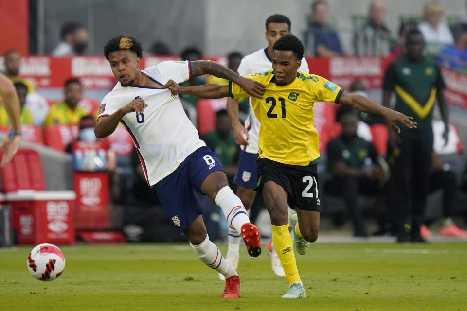 United States&#39; Weston McKennie (8) and Jamaica&#39;s Tyreek Magee (21) chase down the ball during a FIFA World Cup qualifying soccer match, Thursday, Oct. 7, 2021, in Austin, Texas. (AP Photo/Eric Gay)