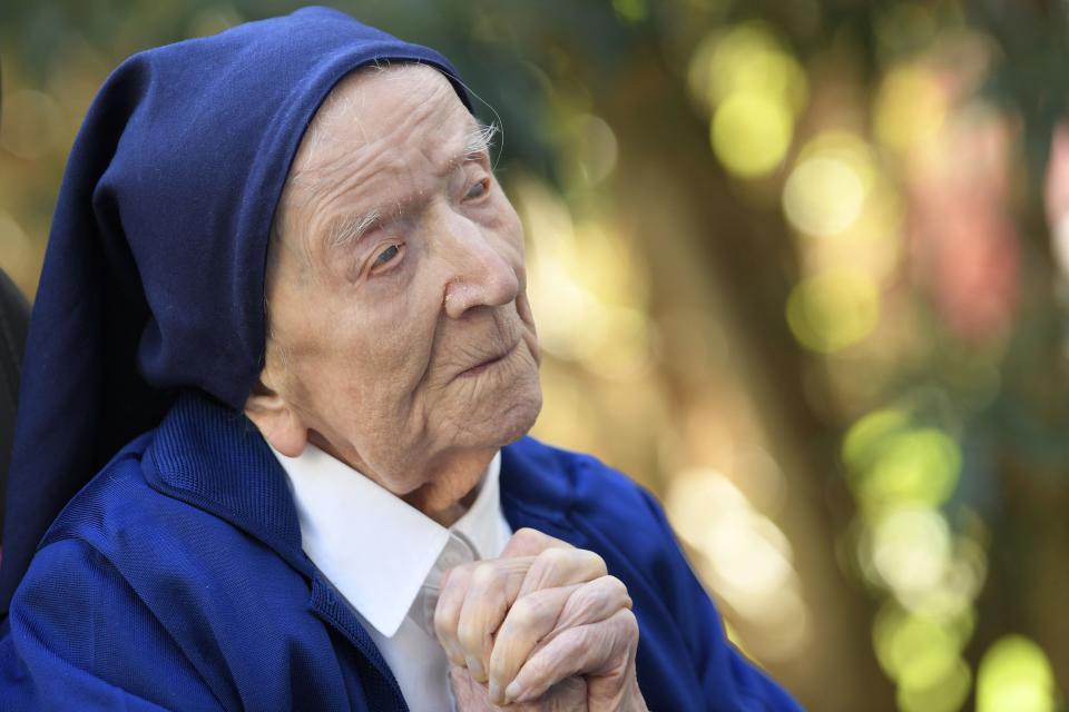 In this file photo taken on February 10, 2021, Sister Andre, Lucile Randon in the registry of birth, the eldest French and European citizen, prays in a wheelchair, on the eve of her 117th birthday in Toulon, southern France, where she has been living since 2009. The world's oldest known person, Lucile Randon, known as Sister Andre, died at age 118, her spokesman said on January 17, 2023.