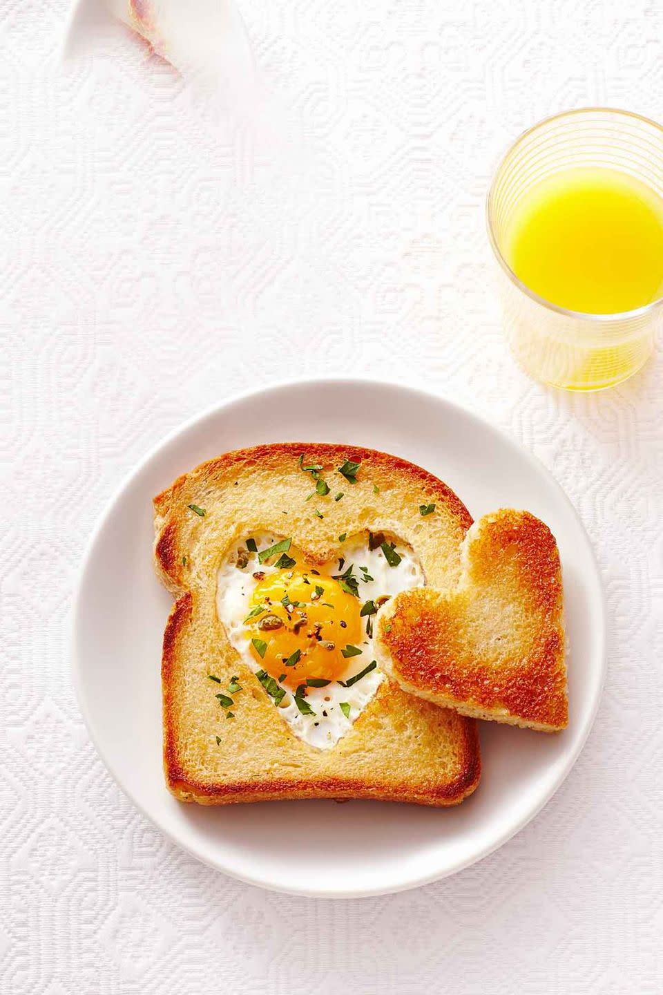 <p>Remind everyone how much you love them with these individual pieces of "Love Toast." Sprinkle with some fresh herbs to make it look straight out of your favorite restaurant. </p><p><strong><em><a href="https://www.womansday.com/food-recipes/food-drinks/recipes/a40385/love-toast-recipe-ghk0215/" rel="nofollow noopener" target="_blank" data-ylk="slk:Get the Love Toast recipe.;elm:context_link;itc:0;sec:content-canvas" class="link ">Get the Love Toast recipe. </a></em></strong></p>