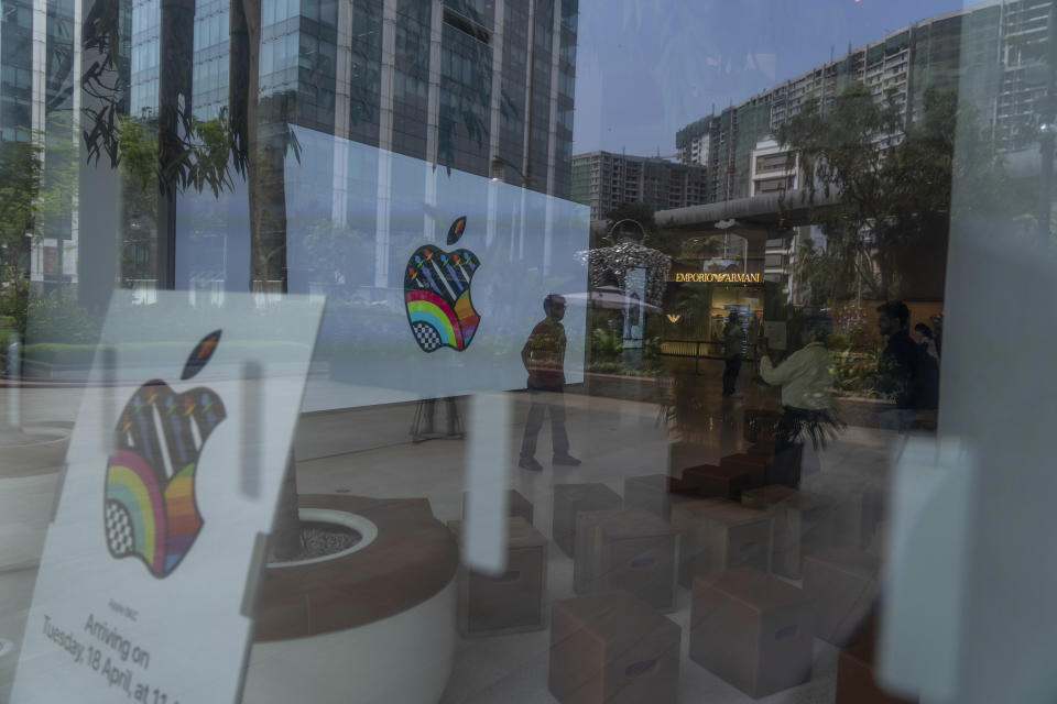 Invitees takes pictures during a press preview of India's first Apple Store in Mumbai, India, Monday, April 17, 2023. Apple will open its first retail store in India in Mumbai on Tuesday. (AP Photo/Rafiq Maqbool)