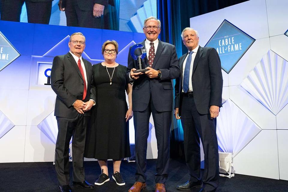 On stage at the Cable Hall of Fame induction ceremony in New York (l. to r.): John Bickham, former president and COO, Charter; Diane Christman, CEO, The Cable Center; Tom E. Adams, former EVP, field operations, Charter; and Tom Rutledge, chairman, Charter.