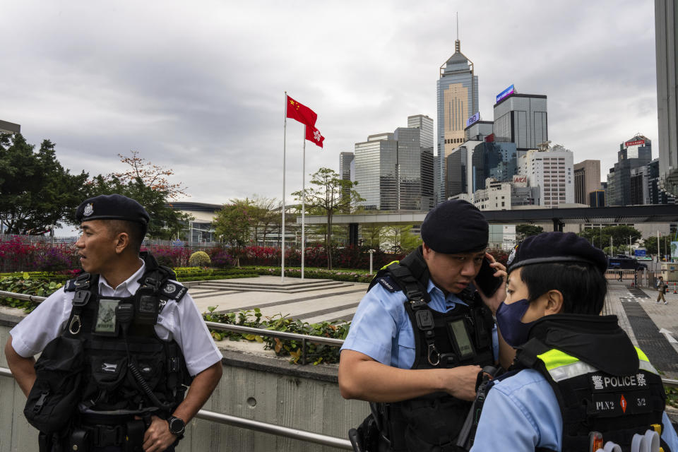 Police officers stand guard outside the Legislative Council in Hong Kong, Tuesday, March 19, 2024. Hong Kong's lawmakers met in a special session to resume debate on a proposed national security law Tuesday, paving the way to grant the government more power to quash dissent in the southern Chinese city. (AP Photo/Louise Delmotte)