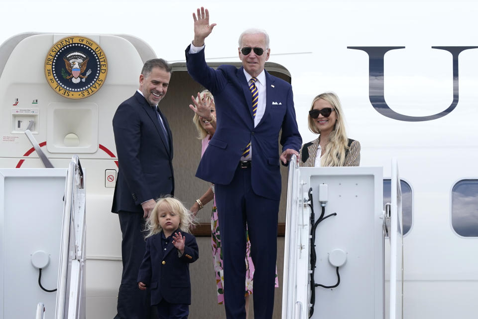 President Joe Biden, center, waves as he is joined by, from left, son Hunter Biden, grandson Beau Biden, first lady Jill Biden, and daughter-in-law Melissa Cohen, as they stand at the top of the steps of Air Force One at Andrews Air Force Base, Md., Wednesday, Aug. 10, 2022. They are heading to South Carolina for a week-long vacation on Kiawah Island. (AP Photo/Susan Walsh)