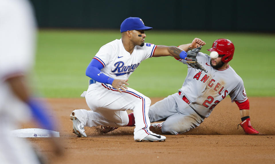 Texas Rangers second baseman Andy Ibanez (77) catches the throws from home as Los Angeles Angels David Fletcher (22) steals second during the first inning of a baseball game, Thursday, Aug. 5, 2021, in Arlington, Texas. (AP Photo/Brandon Wade)