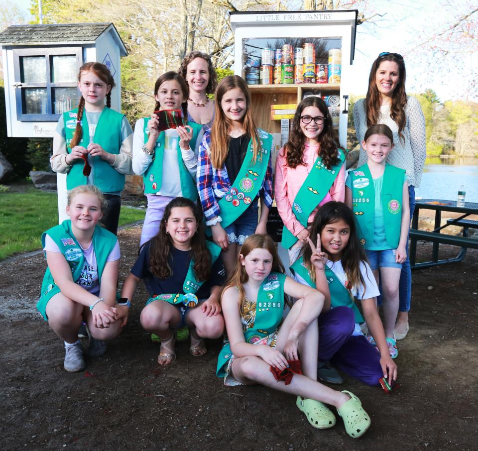 Raynham Junior Girl Scout Troop 82256 completed their Bronze Award community project by delivering and stocking a new Little Free Pantry at Johnson's Pond in Raynham on Thursday, May 12, 2022. Here, from left, front row, Addison Pellerin, Emelia Lombardo, Daphnee McNeice, Kara Conrad; back row, Amber Fitch, Aubrie Shaw, group leader Elisa Freeman, Casey Mulcahy, Olivia Rawlins, Mackenzie MacEachern and group leader Kathy McNeice.