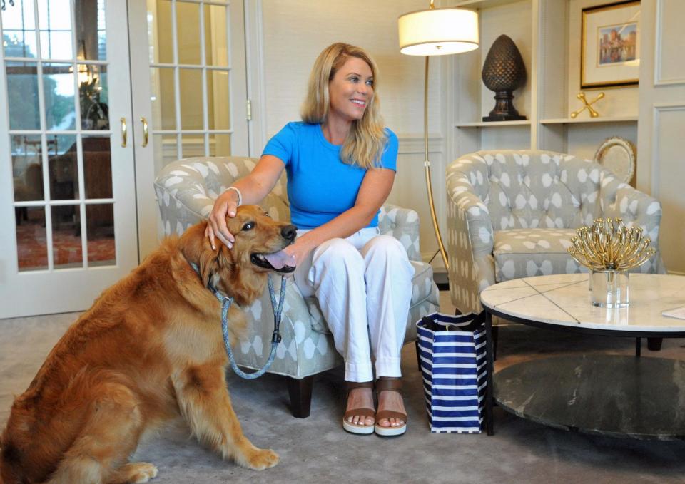 Heather Cyr, 42, of Scituate, and her therapy dog, Tripp, a golden retriever, bring comfort to patients of the NVNA and Hospice. Here she sits with Tripp at the Pat Roche Hospice Home in Hingham on Wednesday, June 28, 2023.