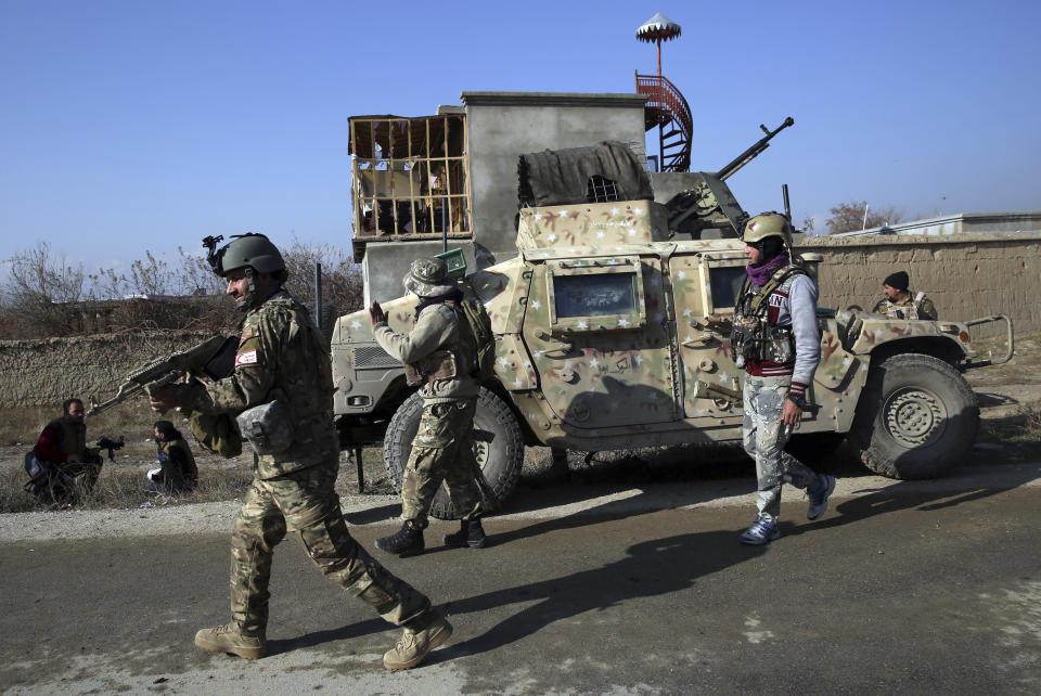 Security personnel arrive near the site of an attack near the Bagram Air Base In Parwan province of Kabul, Afghanistan, Wednesday, Dec. 11, 2019. A powerful suicide bombing Wednesday targeted an under-construction medical facility near the Bagram Air Base, the main American base north of the capital Kabul, the U.S. military said. (AP Photo/Rahmat Gul)