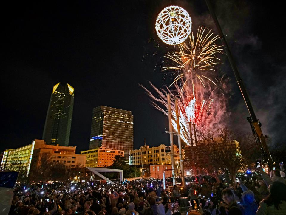 Fireworks light the nighttime sky as the ball rises during Arts Council OKC's New Year's Eve celebration, Opening Night 2023, in Bicentennial Park in downtown Oklahoma City.