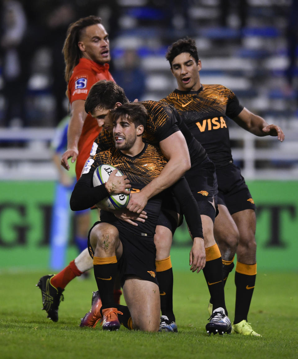 Juan Cruz Mallia of Argentina's Jaguares, center, celebrates after scoring a try against Japan's Sunwolves at a Super Rugby match in Buenos Aires, Argentina, Friday, June 14, 2019. (AP Photo/Gustavo Garello)