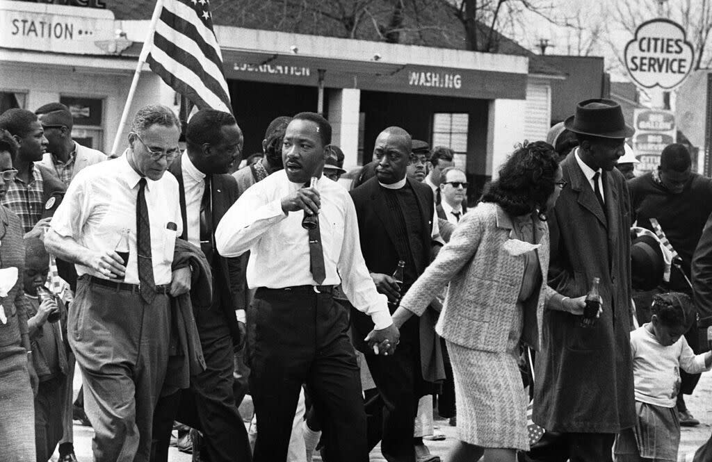 March 1965:  Martin Luther King (1929  - 1968) and his wife Coretta Scott King lead a civil rights march from Selma, Alabama, to the state capital in Montgomery. On the left (holding bottle) is American diplomat Ralph Bunche (1904 - 1971). (Photo by William Lovelace/Express/Getty Images)