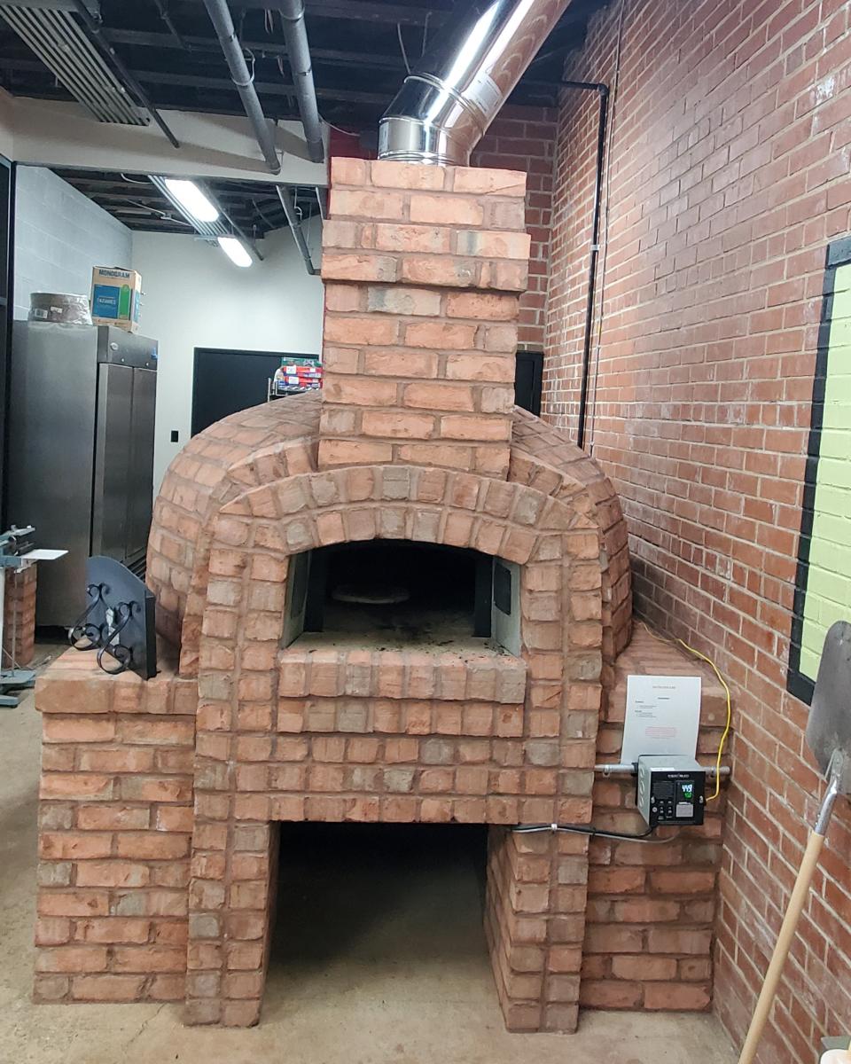 Pour Folk Provisions owners ordered a brick pizza oven kit in August. The staff is training on the recently completed oven now and will begin offering pizza pies to the public on Feb. 25.