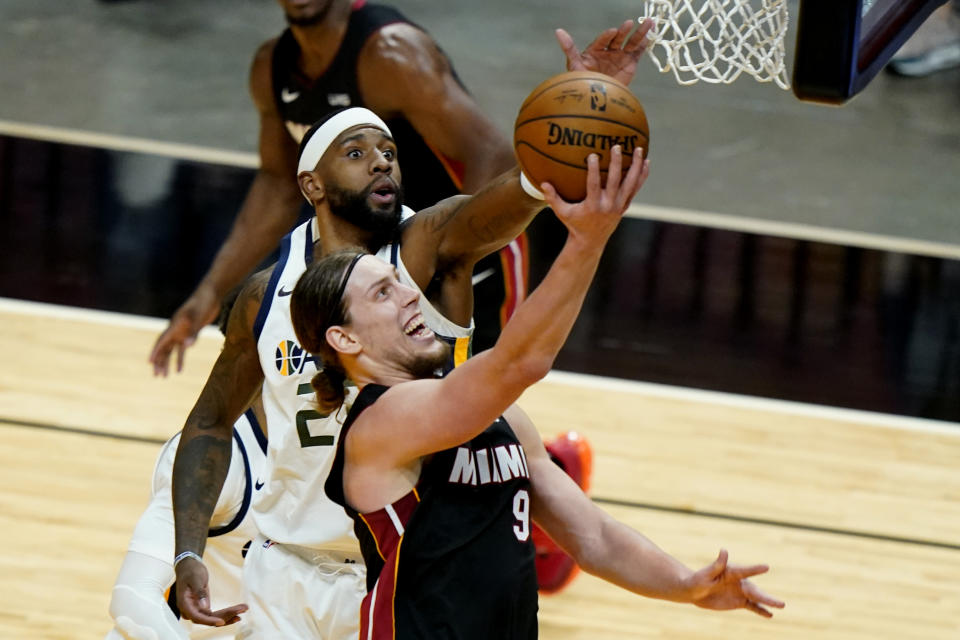 Miami Heat forward Kelly Olynyk (9) goes to the basket as Utah Jazz forward Royce O'Neale defends during the first half of an NBA basketball game, Friday, Feb. 26, 2021, in Miami. (AP Photo/Lynne Sladky)