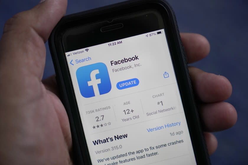 The Facebook app is shown on a smart phone, Friday, April 23, 2021, in Surfside, Fla. Facebook says, Thursday, May 27, it will no longer remove claims that COVID-19 is man-made or manufactured from its apps. The change comes "in light of ongoing investigations into the origin of COVID-19 and in consultation with public health experts," Facebook said. .(AP Photo/Wilfredo Lee)