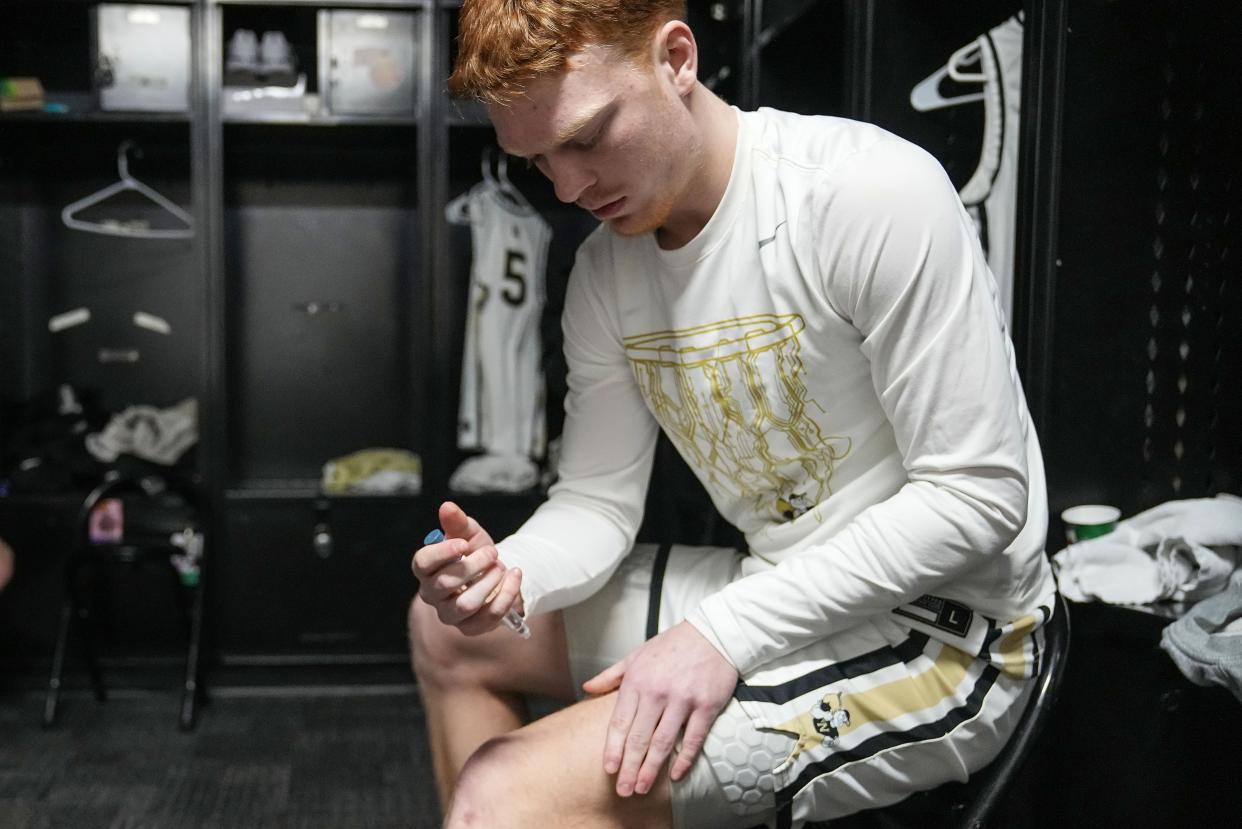 Aaron Fine gives himself insulin Feb. 20 ahead of the game against Mississinewa at Noblesville High School in Noblesville, Indiana.