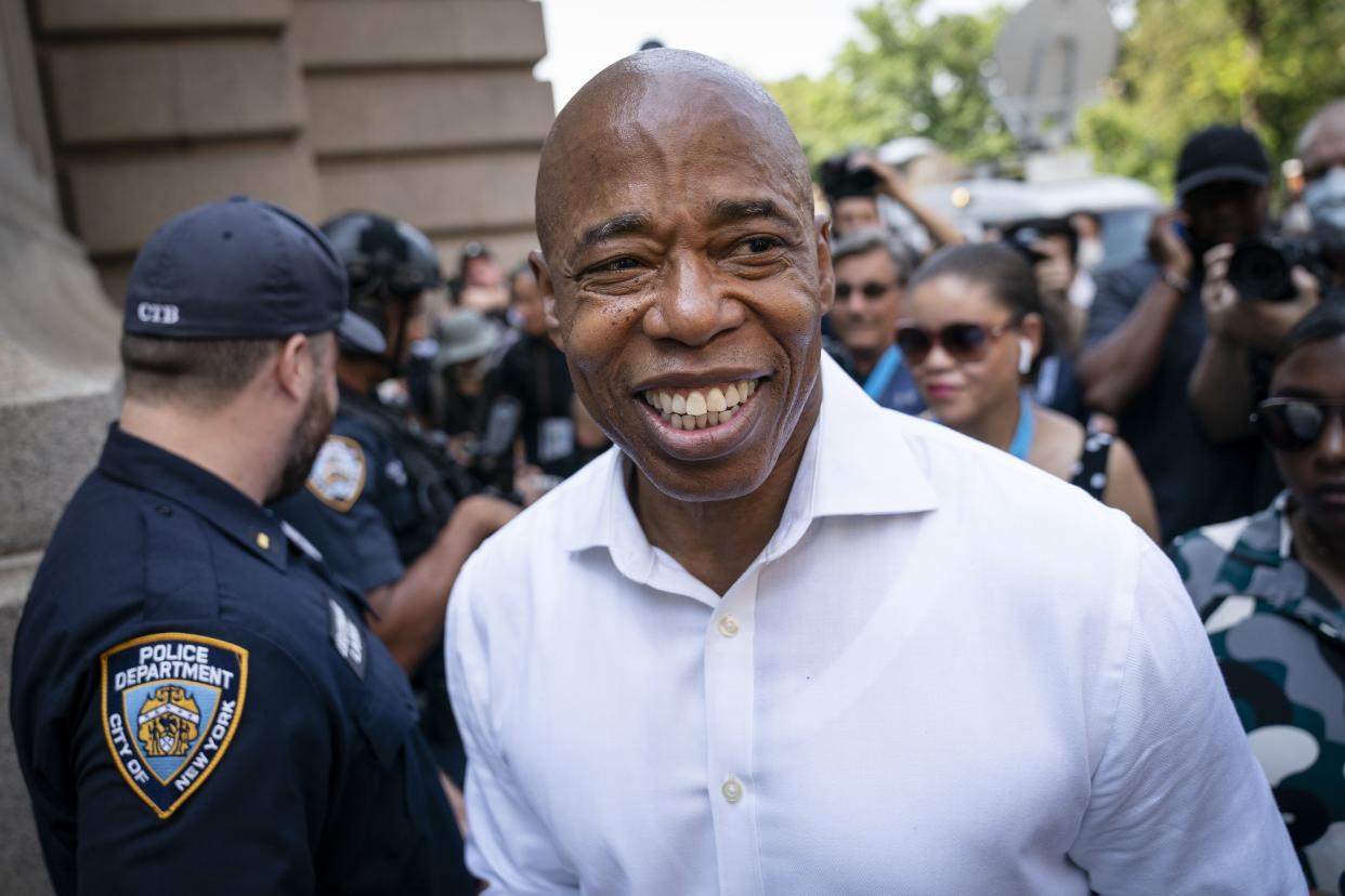 Brooklyn Borough President and a Democratic mayoral candidate Eric Adams greets NYPD officers as participants gather for a march through the financial district during a parade honoring essential workers for their efforts in getting New York City through the COVID-19 pandemic, Wednesday, July 7, in New York. 