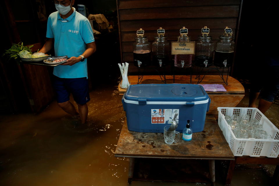 員工涉水準備食材，圖片來源：REUTERS