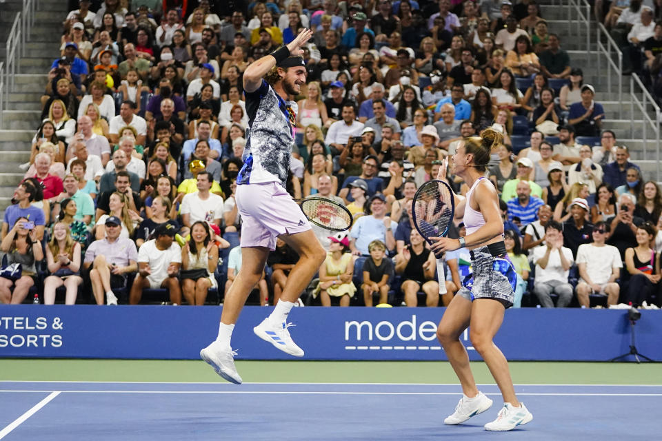 Stefanos Tsitsipas, left, and Maria Sakkari, of Greece, right, celebrate a point during "The Tennis Plays for Peace" exhibition match to raise awareness and humanitarian aid for Ukraine Wednesday, Aug. 24, 2022, in New York. The 2022 U.S. Open Main Draw will begin on Monday, Aug. 29, 2022. (AP Photo/Frank Franklin II)