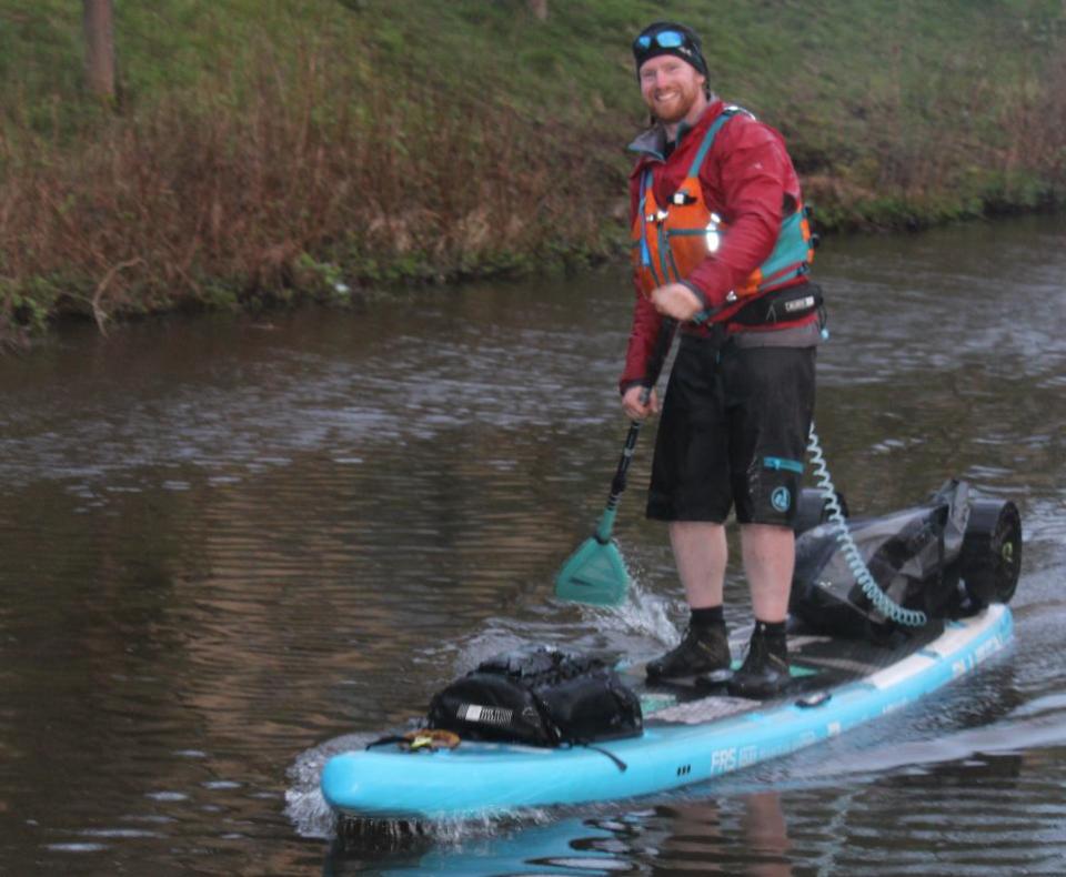 Bradford Telegraph and Argus: Jonathon Callow at the finish of a his 300km paddle board challenge.