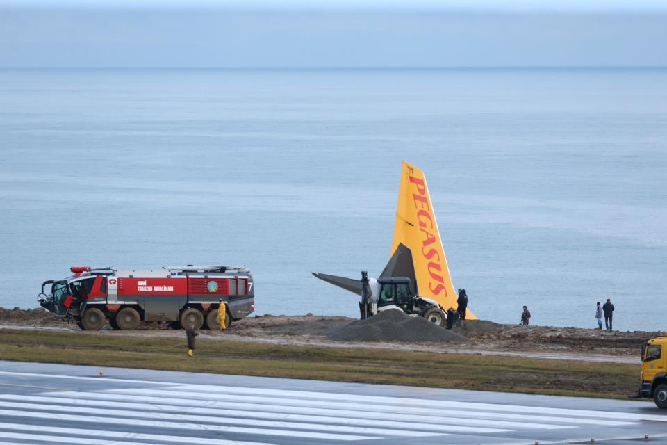 <p>Trucks try to pull back stuck airplane at Trabzon Airport on Jan. 14, 2018 in Trabzon, Turkey. Pegasus airplane carrying 162 passengers is seen stuck in mud as it skidded off the runway after landing in Trabzon Airport, Turkey early Sunday on January 14, 2018. 162 passengers and crew on board were safely evacuated. (Photo: Hakan Burak Altunoz/Anadolu Agency/Getty Images) </p>