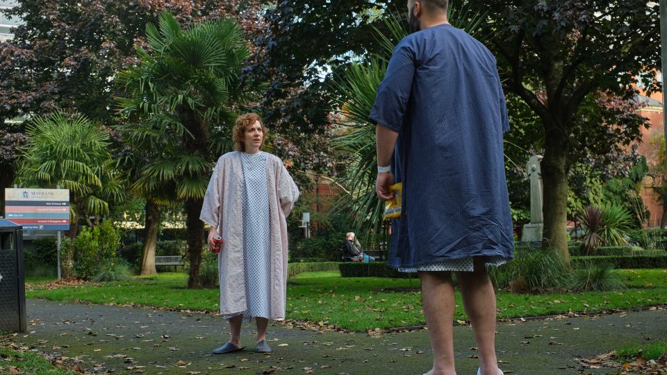 Anna (Katherine Parkinson) in a hospital gown stood opposite Sam (Youssef Kerkour) in Significant Other