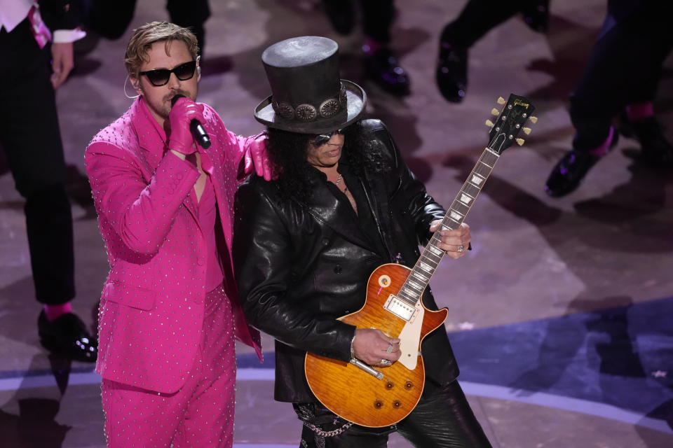 Ryan Gosling, left, performs the song "I'm Just Ken" from the movie "Barbie" with Slash, right, playing the guitar during the Oscars on Sunday, March 10, 2024, at the Dolby Theatre in Los Angeles. (AP Photo/Chris Pizzello)