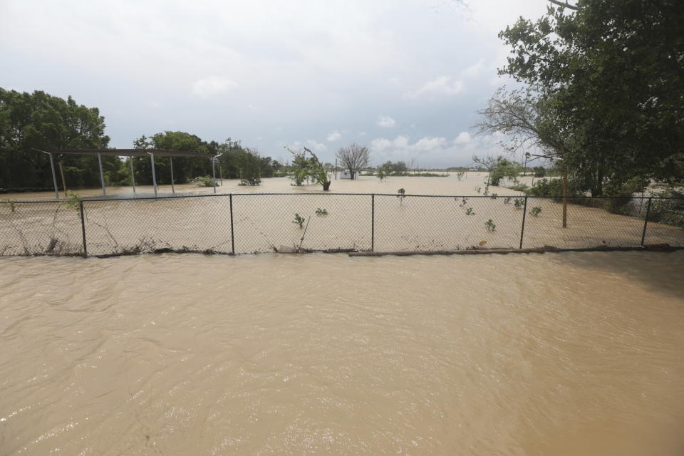 A mobile home in an unincorporated area in east Harris County near Houston on Sunday morning, May 5, 2024, is surrounded by flood waters caused by the nearby San Jacinto River, which overflowed due to heavy rainfall earlier this week. (AP Photo/Lekan Oyekanmi)