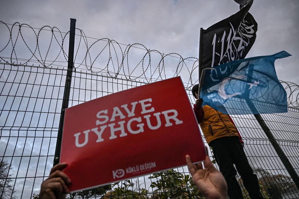 A supporters of China's Muslim Uighur minority holds a placard reading 'Save Uighur' during a demonstration in front of China Consulate in Istanbul.Photo: Ozan Kose/AFP/Getty