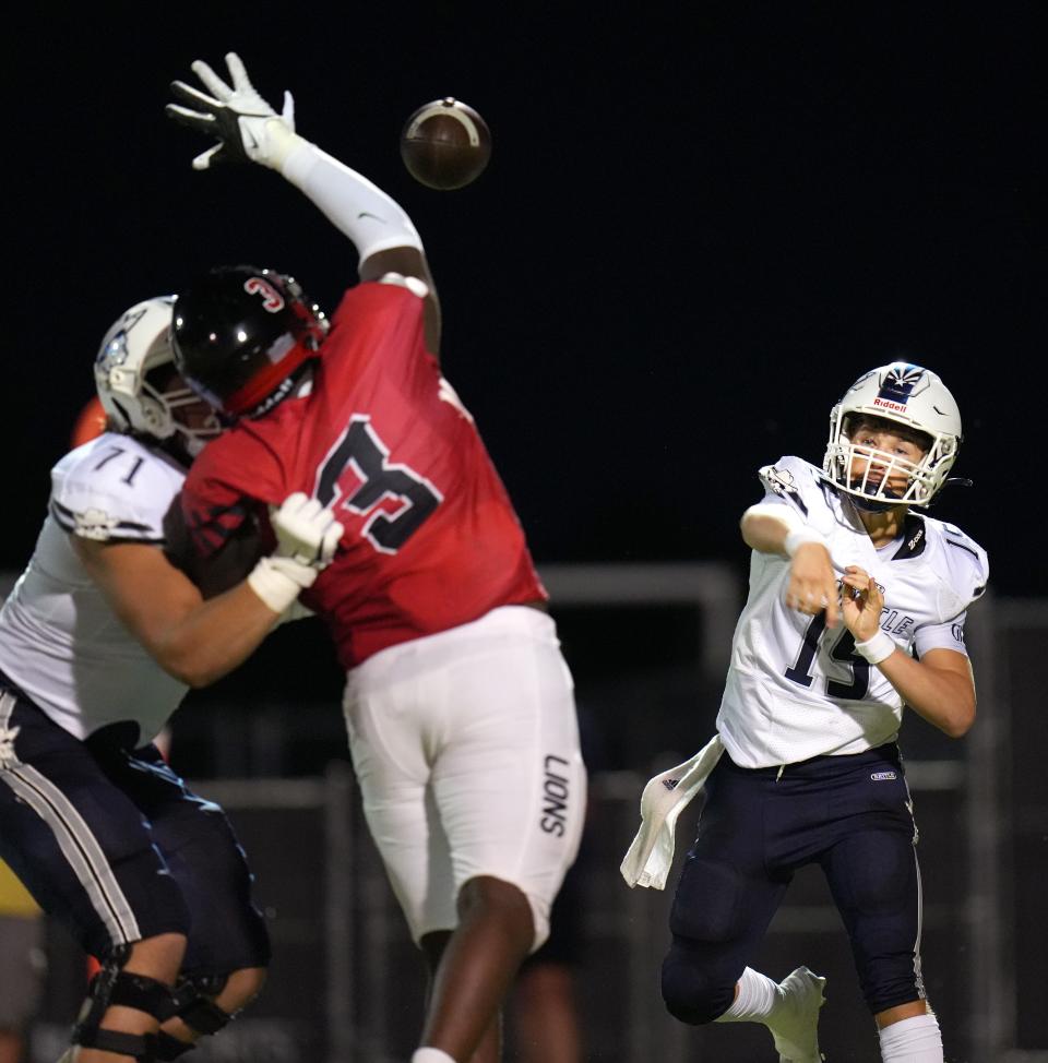 Pinnacle quarterback Wyatt Horton (15) throws the ball as Liberty's My'Keil Gardner (3) defends at Liberty High School in Peoria on Saturday, Sept. 10, 2022.