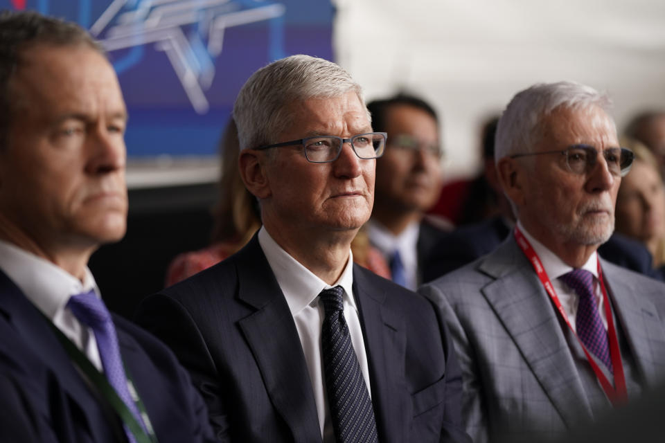 Apple CEO waits to hear President Joe Biden speak about his economic agenda after touring the building site for a new computer chip plant for Taiwan Semiconductor Manufacturing Company, Tuesday, Dec. 6, 2022, in Phoenix. (AP Photo/Patrick Semansky)