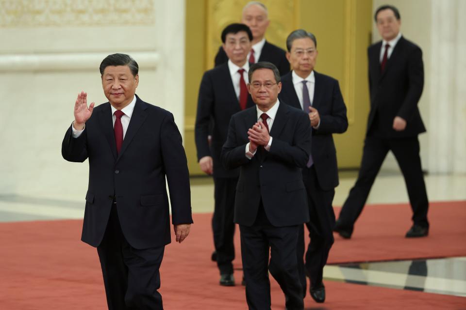 Xi Jinping, Li Qiang, and other members of China's new top leadership walk in order of their rank.