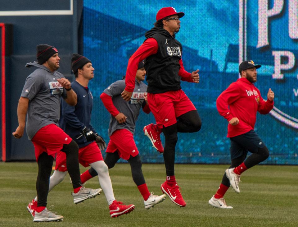 David Hamilton, center, and others warm up on media day at Polar Park Wednesday.