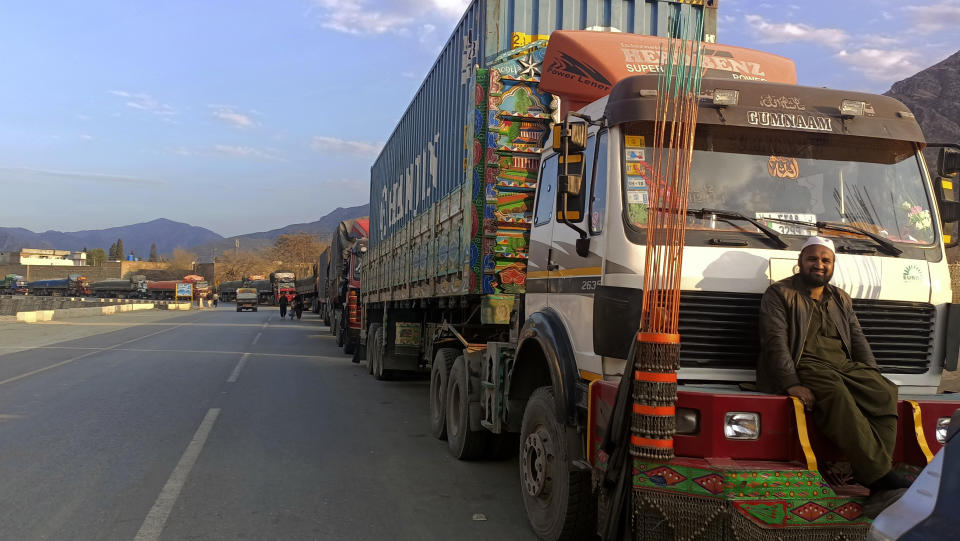 Stranded trucks loaded with supplies for Afghanistan, line up on a highway after Afghan Taliban rulers closed a key border crossing point Torkham, in Landi Kotal, an area Pakistan's district Khyber along Afghan border, Tuesday, Feb. 21, 2023. The main crossing on the Afghan-Pakistan border remained shut Tuesday for the third straight day, officials said, after Afghanistan's Taliban rulers earlier this week closed the key trade route and exchanged fire with Pakistani border guards. (AP Photo/Qazi Rauf)