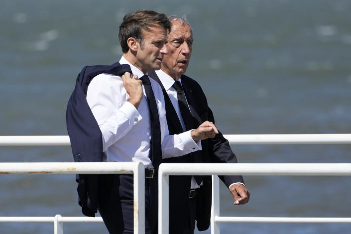 French President Emmanuel Macron takes a walk with his Portuguese counterpart Marcelo Rebelo de Sousa on a walkway outside the venue hosting the United Nations Ocean Conference in Lisbon, Thursday, June 30, 2022. From June 27 to July 1, the United Nations is holding its Oceans Conference in Lisbon expecting to bring fresh momentum for efforts to find an international agreement on protecting the world's oceans. (AP Photo/Armando Franca)