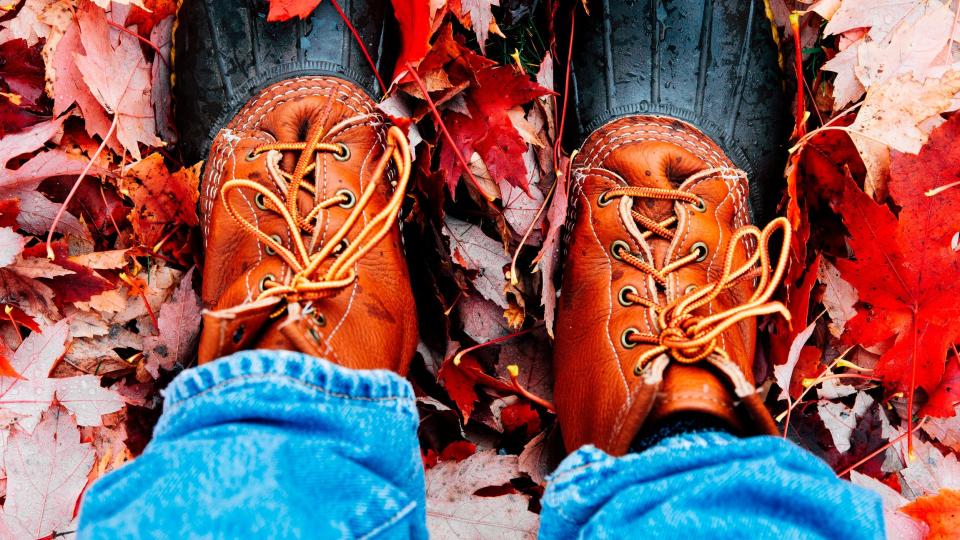 rain boots on red leaves strolling outside during autumn