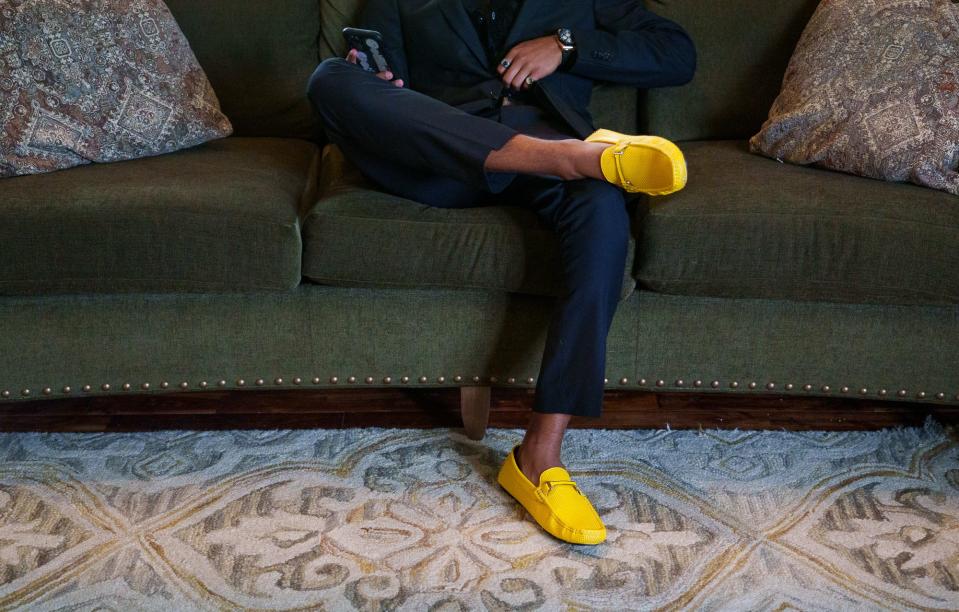 Cade Thompson, 18, senior at Ben Davis High School, sits on the couch Saturday, May 13, 2023, of his Avon High School prom date Vivian Eagle, 17, a junior at Avon. Both Thompson and Eagle had and beat osteosarcoma, a cancer of the bone. The cancer ribbon color of osteosarcoma is yellow. 