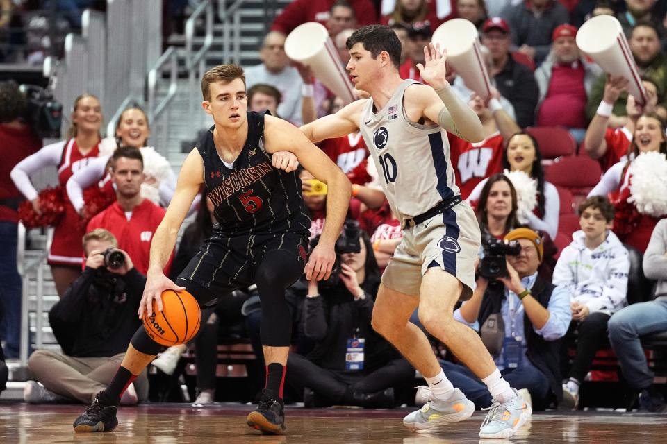 Wisconsin forward Tyler Wahl handles the ball against Penn State guard Andrew Funk on Tuesday night. Wahl was returning after three games out due to an ankle injury.