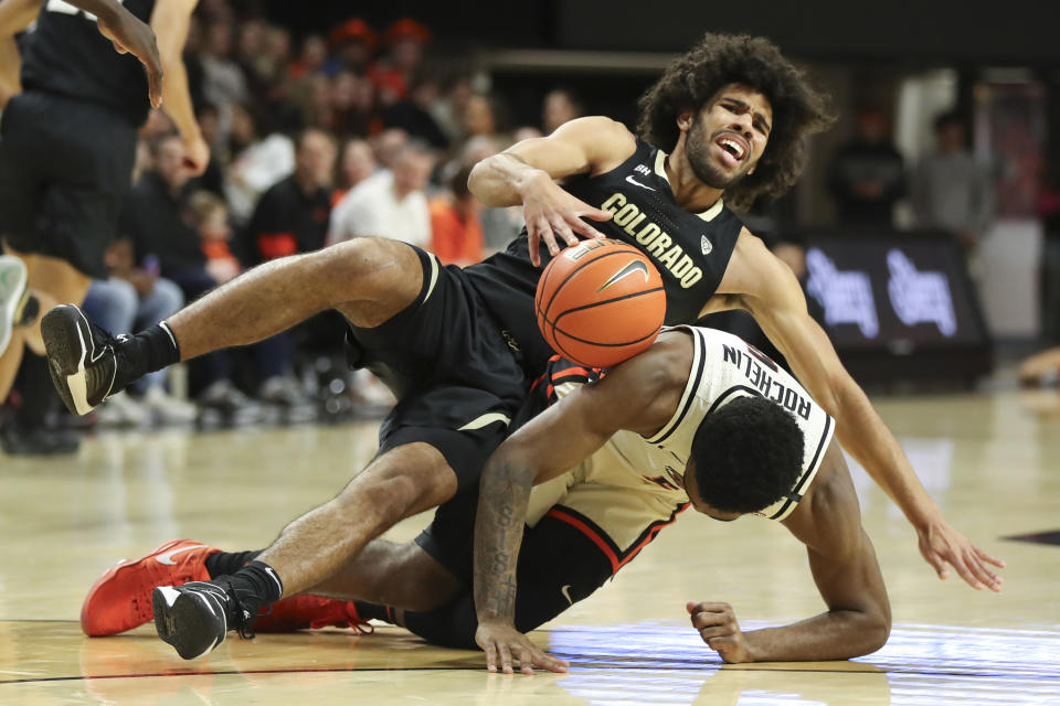 Colorado guard Javon Ruffin, top, and Oregon State guard Justin Rochelin, bottom, fall to the floor during the first half of an NCAA college basketball game Saturday, March 9, 2024, in Corvallis, Ore. (AP Photo/Amanda Loman)