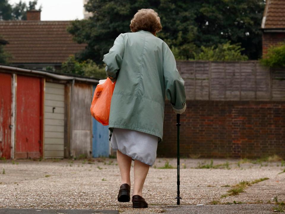 A woman walks past car garages near the High Street in Stratford: AFP/Getty